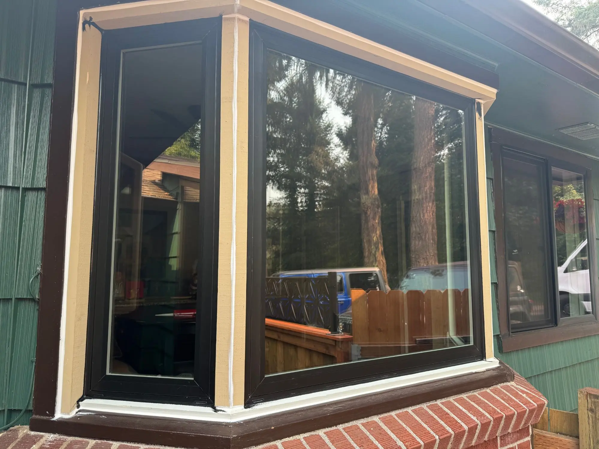 New bay window units installed, with the surrounding trim primed and ready for paint