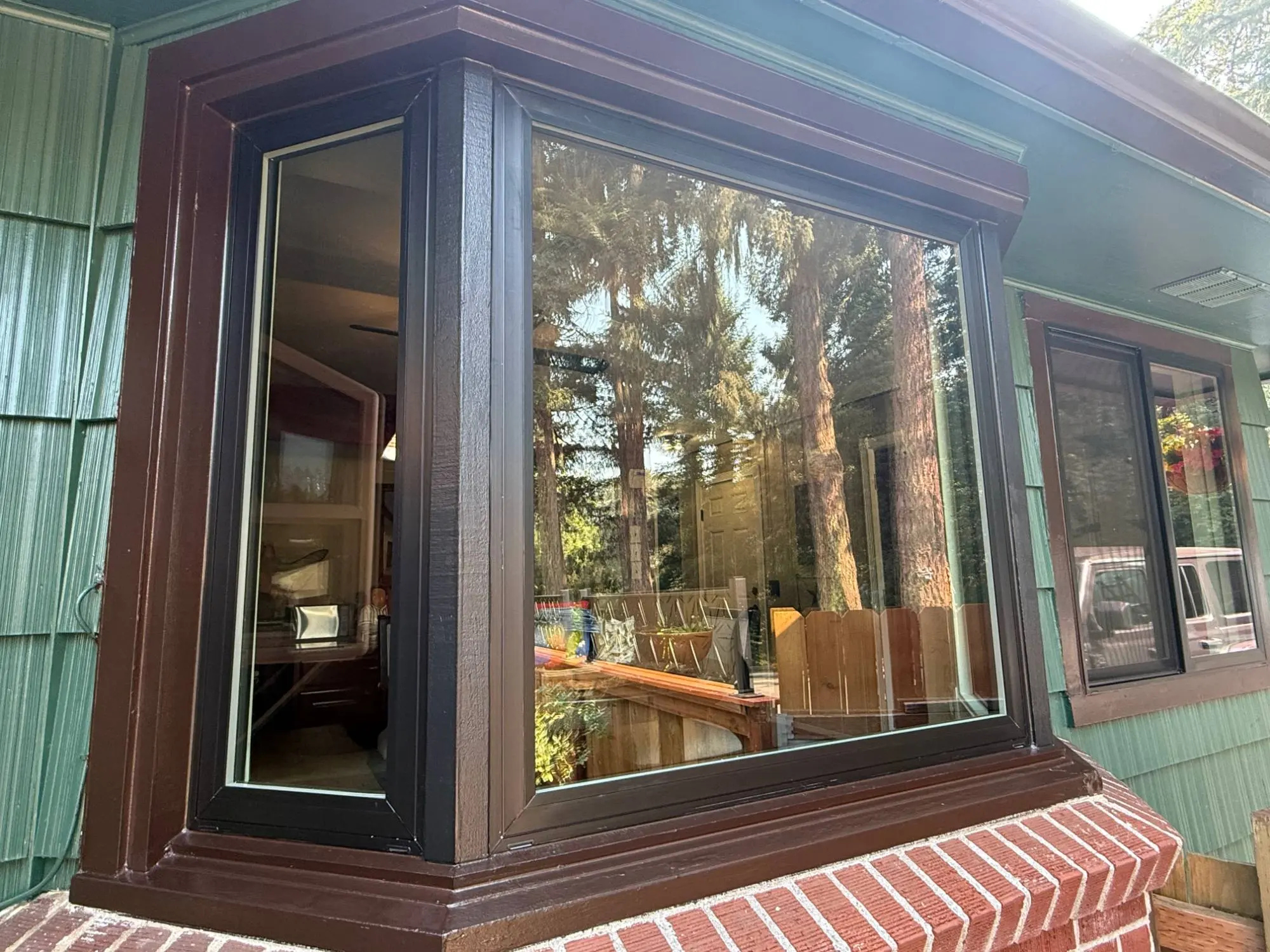 Completed bay window with new frames and painted brown trim