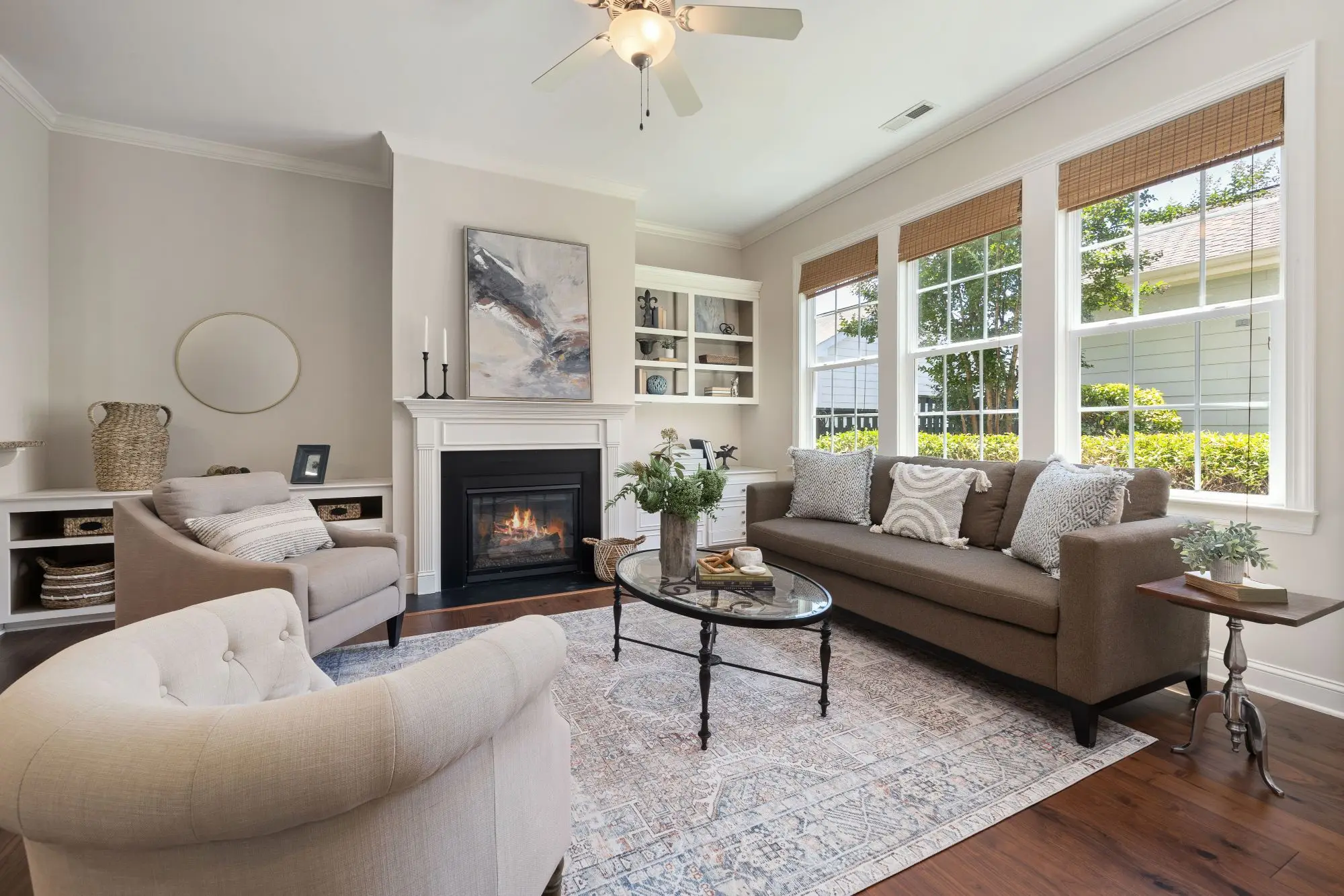 Bright living room with tall white double-hung windows letting in natural daylight